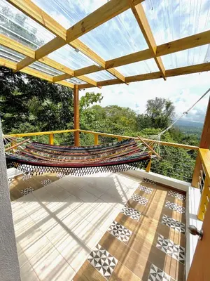 a balcony with a hammock and a glass roof at Villa Leon in Jarabacoa
