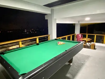 a pool table on a balcony with a view at Villa Leon in Jarabacoa