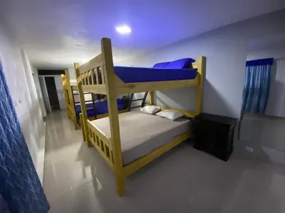 a bedroom with two bunk beds in a room at Villa Leon in Jarabacoa