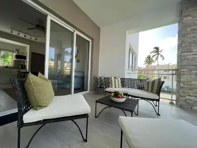 a living room with a couch and chairs and a table at Casa Mulata Paseo del Mar Pool & Playa in Punta Cana