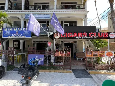 a motorcycle parked in front of a building with flags at Casa Mulata Paseo del Mar Pool & Playa in Punta Cana