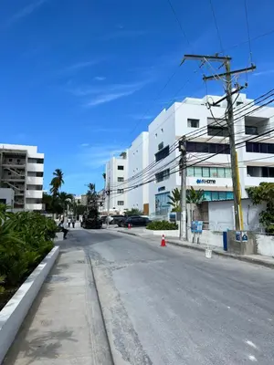 an empty street in front of a white building at Casa Mulata Paseo del Mar Pool & Playa in Punta Cana