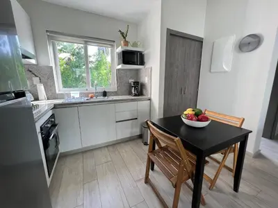 a kitchen with a table with a bowl of fruit on it at Casa Mulata Paseo del Mar Pool & Playa in Punta Cana