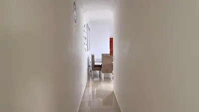 a hallway leading to a dining room with a table at MB Apartment - A in San Felipe de Puerto Plata