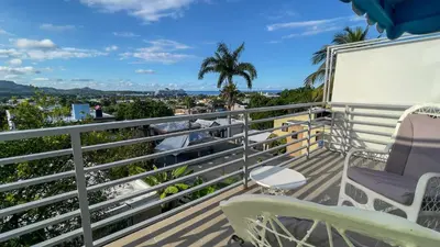 a balcony with chairs and a view of the ocean at MB Apartment - A in San Felipe de Puerto Plata