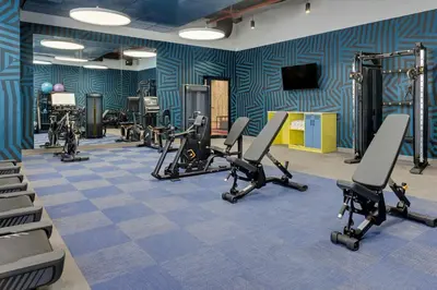a gym with several treadmills and exercise bikes at Aloft Santo Domingo Piantini in Santo Domingo