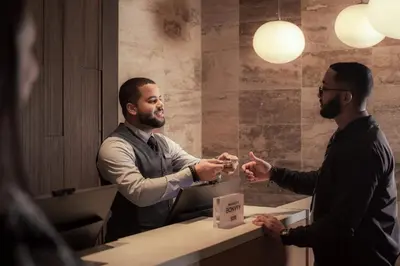 two men shaking hands in a room at Santo Domingo Marriott Hotel Piantini in Santo Domingo