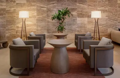 a waiting room with chairs and a table and two lamps at Santo Domingo Marriott Hotel Piantini in Santo Domingo
