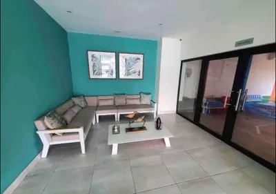 a living room with a couch and a table at VIP DELUXE AND TOWER J7_POOL_GYM_SAUNE_WIFE in Santo Domingo