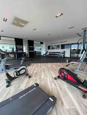a gym with treadmills and elliptical machines at VIP DELUXE AND TOWER J7_POOL_GYM_SAUNE_WIFE in Santo Domingo