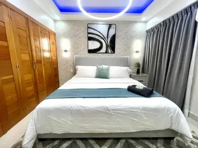 a bedroom with a large bed with a blue ceiling at VIP DELUXE AND TOWER J7_POOL_GYM_SAUNE_WIFE in Santo Domingo