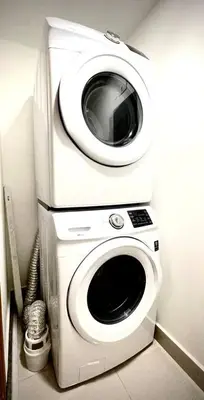 a washing machine with a microwave on top of it at VIP DELUXE SUITE AND TOWER E11 POOL_GYM_SAUNE_WIFE in Santo Domingo