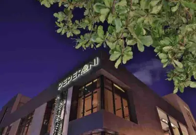 a building with a sign on top of it at night at VIP DELUXE SUITE AND TOWER E11 POOL_GYM_SAUNE_WIFE in Santo Domingo
