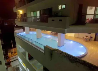 a building with a swimming pool in the middle at VIP DELUXE SUITE AND TOWER E11 POOL_GYM_SAUNE_WIFE in Santo Domingo