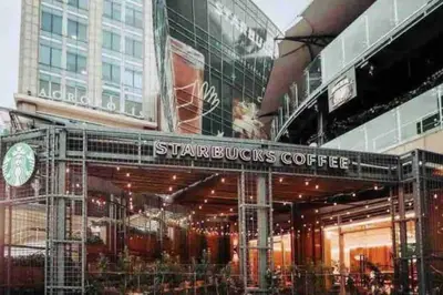 a store front with a sign that reads starbucks coffee at Luxury 1 BDR , Rooftop POOL, Gym, in Downtown D2 in Santo Domingo
