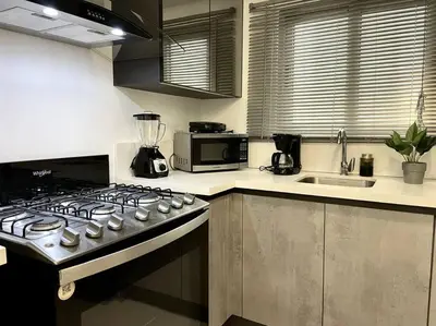 a kitchen with a stove and a counter top at Luxury 1 BDR , Rooftop POOL, Gym, in Downtown D2 in Santo Domingo