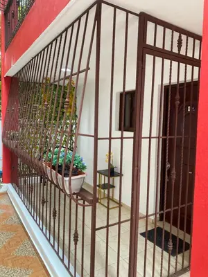 a iron gate with a potted plant in a room at Apartament para pareja muy acogedor y privado in Cafemba