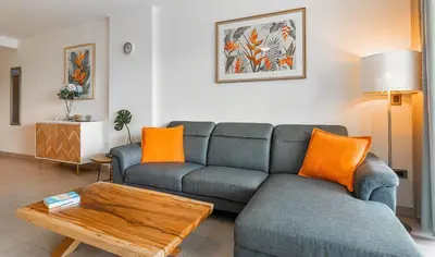 a living room with a couch and a table at The Garden | Beauty NEW 2 BR With Pool View in Punta Cana