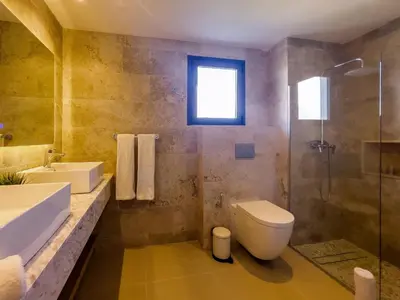 a bathroom with a toilet and a sink and a shower at The Garden | Beauty NEW 2 BR With Pool View in Punta Cana