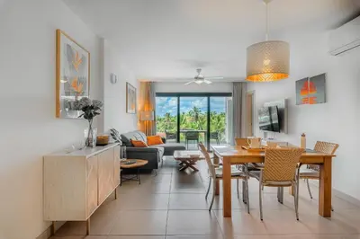 a dining room and living room with a dining table at The Garden | Beauty NEW 2 BR With Pool View in Punta Cana