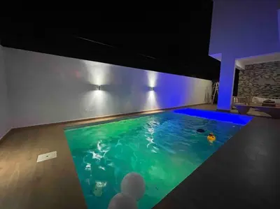 a large swimming pool in a house with blue lighting at LUXURY_VIP_Villa_LifeStyle puerto plata in San Felipe de Puerto Plata