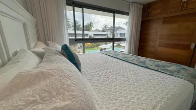 a bedroom with a white bed with a large window at 3 Bedroom Beach Villa With Parking in Las Terrenas