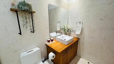a bathroom with a sink and a toilet and a mirror at 3 Bedroom Beach Villa With Parking in Las Terrenas
