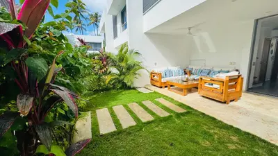 a backyard with a couch and a grass yard at 3 Bedroom Beach Villa With Parking in Las Terrenas