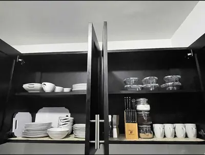 a kitchen cabinet with plates and bowls and dishes at Joel Arturo Residences in Licey al Medio