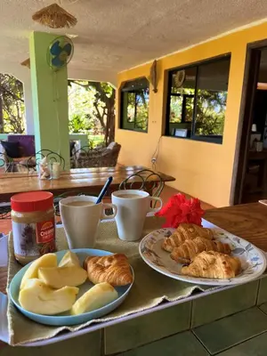 a table with two plates of bread and pastries at La Hacienda Hostel-Rancho in Las Galeras