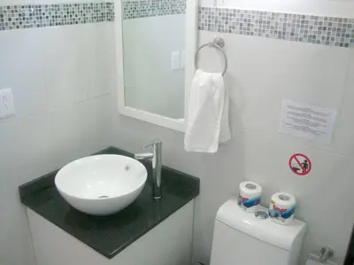 a white bathroom with a sink and a toilet at Villa Palmas Doradas in Cabarete