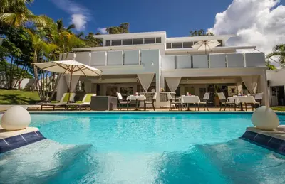 a house with a swimming pool in front of a house at Casa Veintiuno in Sosúa