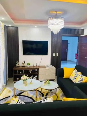 a living room with a couch and two tables at Confortable y lujoso apartamento en santiago in Santiago de los Caballeros