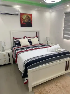 a white bedroom with a large bed in it at Confortable y lujoso apartamento en santiago in Santiago de los Caballeros