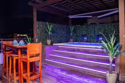 a stage with stairs and a table and chairs at 8BR Penthouse Jacuzzi, Pool Table Terrace in Los Prados
