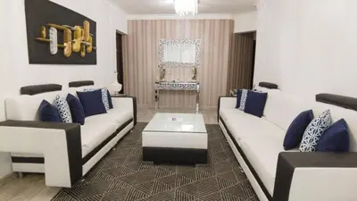 a living room with white couches and blue pillows at 8BR Penthouse Jacuzzi, Pool Table Terrace in Los Prados