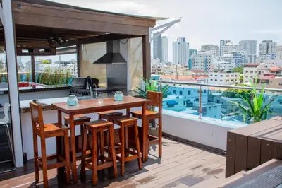 a kitchen with a table and chairs on a balcony at 8BR Penthouse Jacuzzi, Pool Table Terrace in Los Prados