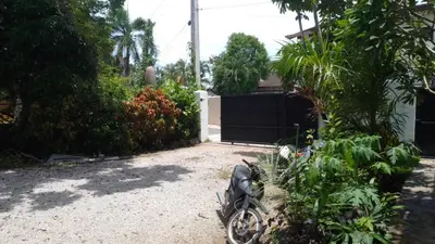 a motorcycle parked in the driveway of a house at NEW MORINGA in Las Terrenas