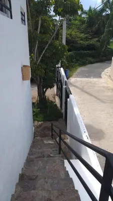 a fence next to a sidewalk next to a building at NEW MORINGA in Las Terrenas