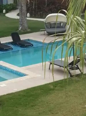 two chairs and a table next to a swimming pool at Casa Larimar 214 - Vibe Residence in La Laguna