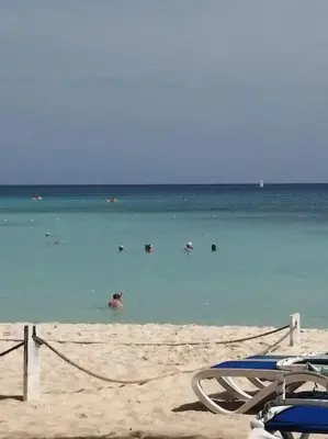a group of people in the water at the beach at Casa Larimar 214 - Vibe Residence in La Laguna