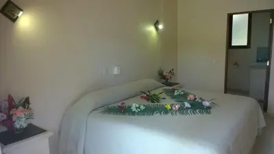 a white bed with flowers on it in a room at Villa La Plantacion in Las Galeras