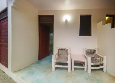 two chairs and a table in a room at Villa La Plantacion in Las Galeras