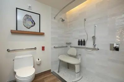 a bathroom with a toilet and a sink at Courtyard by Marriott Santo Domingo Piantini in Santo Domingo