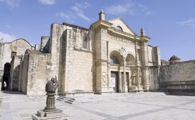 a large stone building with a statue in front of it at Hostal María Fernanda in Santo Domingo