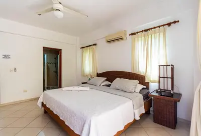 a bedroom with a bed and a ceiling fan at Alicia Beach, Hispaniola Sol! in Sosúa