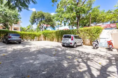 a car parked in a parking lot with two motorcycles at Alicia Beach, Hispaniola Sol! in Sosúa
