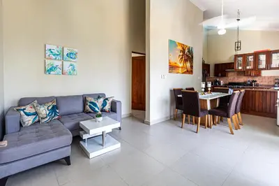 a living room with a couch and a table at Novus Mare, Cabarete center! in Cabarete