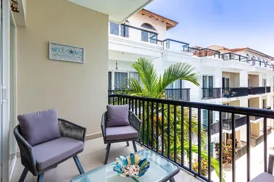 a balcony with two chairs and a table at Novus Mare, Cabarete center! in Cabarete