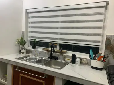 a kitchen counter with a sink and a window at VILLA GRANDEZZA in Punta Cana